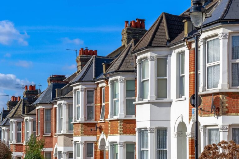 Row of traditional terraced houses with brick and white exteriors