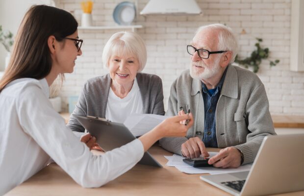 Elderly couple speaking with a mortgage adviser