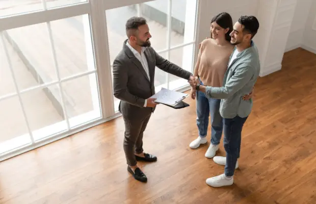 Three-people-shaking-hands-in-a-bright-room